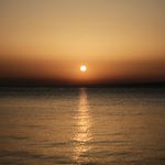 Small icon of peaceful sunset over calm water